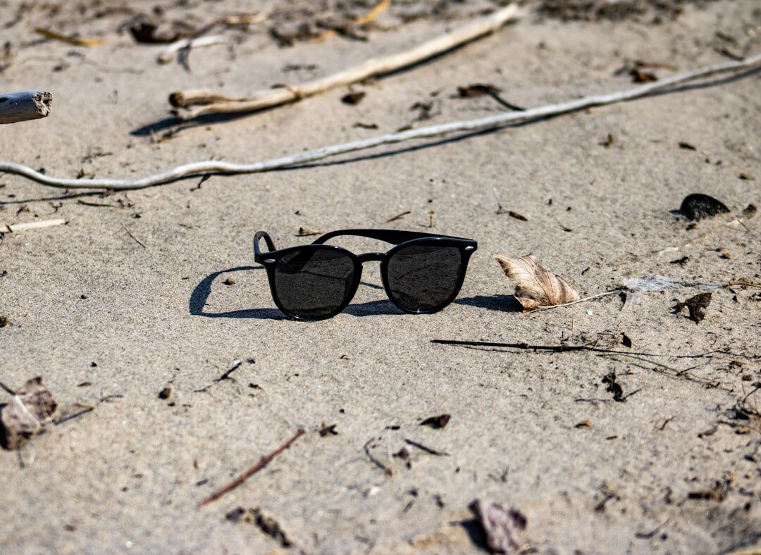 Polarized luxury sunglasses on beach sand