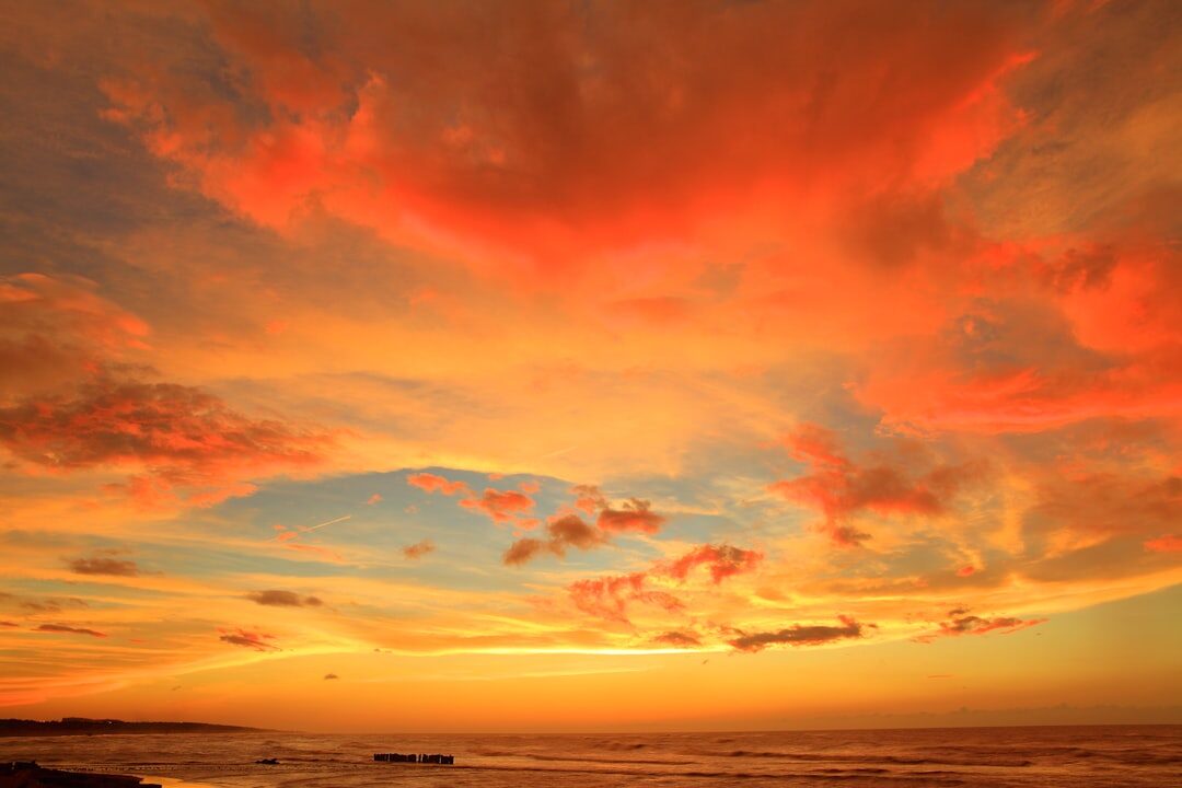 Golden hour sunset over Punta del Este coastline with luxury watch overlay